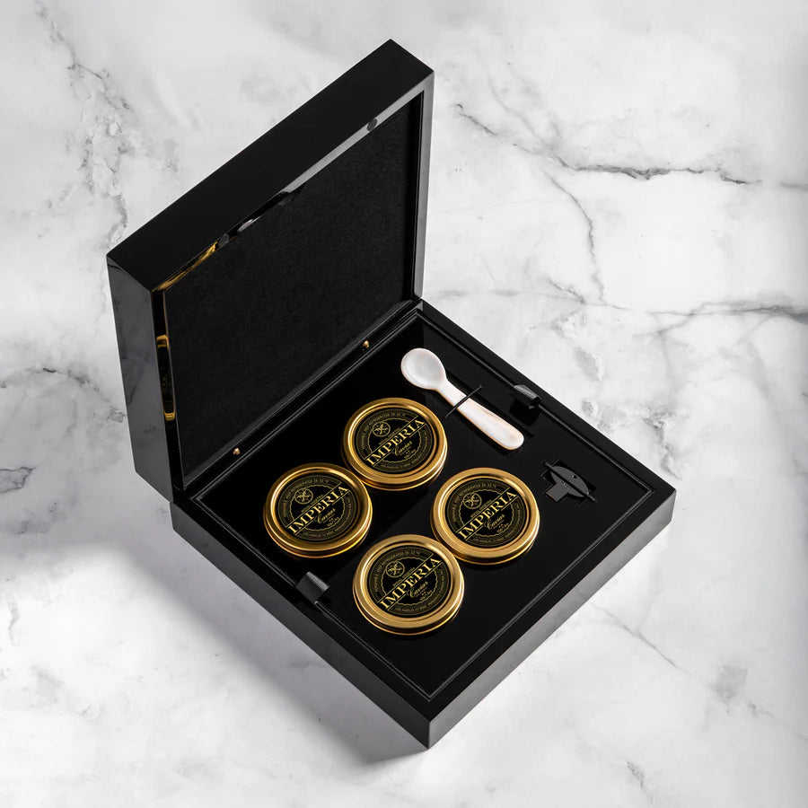 an open imperia caviar gift boz with four imperia caviar tins, one mother-of-pearl spoon and a caviar tin opener