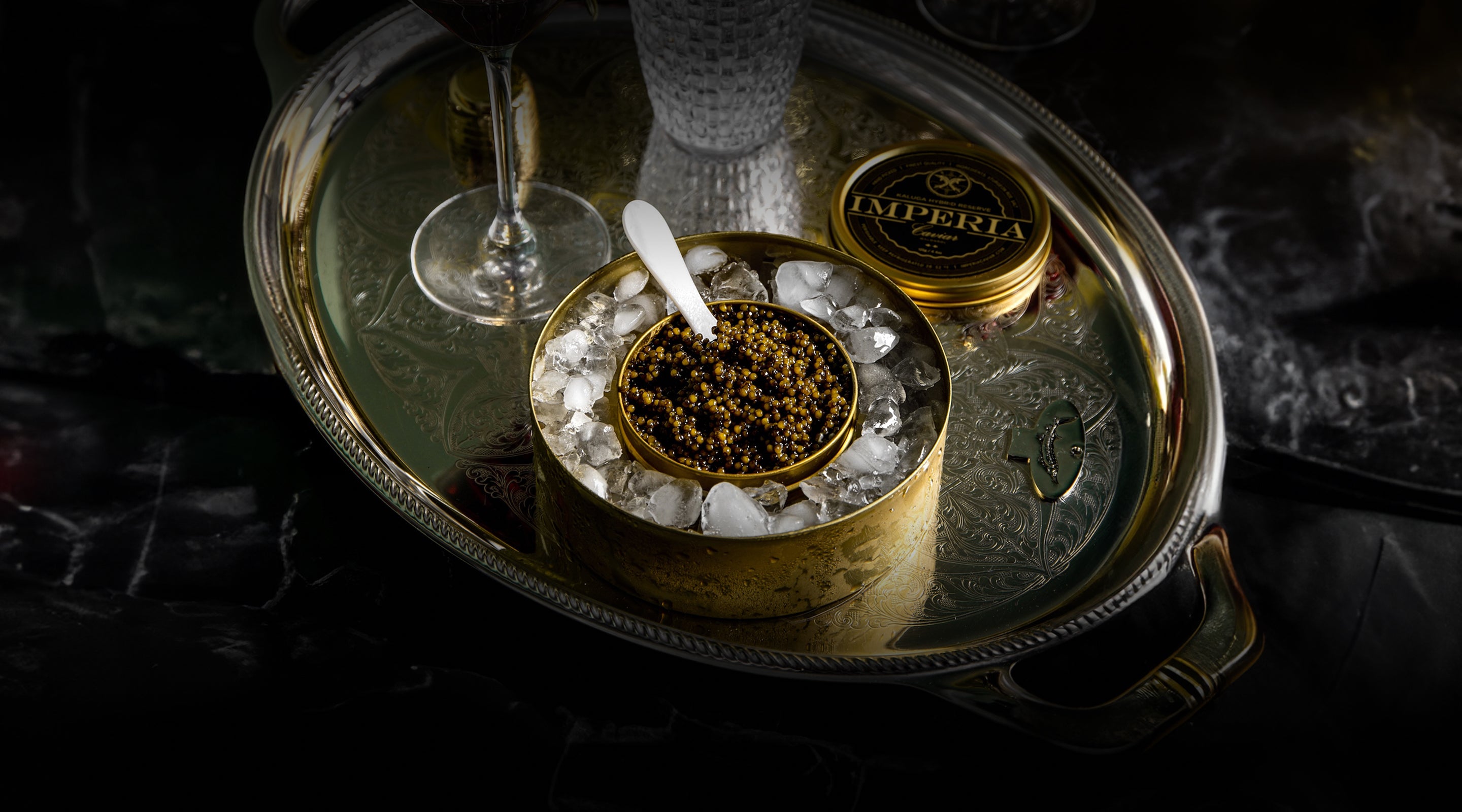 Caviar on ice in a gold container.
